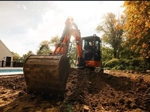 Excavator Service - MAC Excavation & Landscape Excavator service in action at residential property by MAC Excavation & Landscape in South Shore MA
