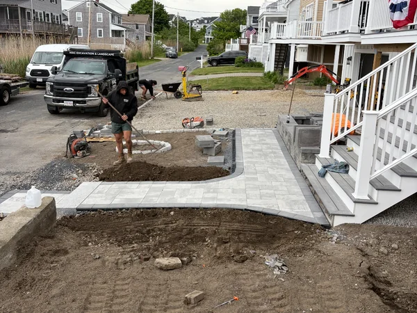 New front entry paver walkway and landing with charcoal border installed at a coastal Marshfield, MA home