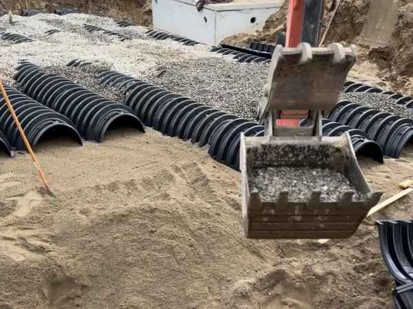 Excavator and work truck on septic installation job site by MAC Excavation & Landscape in South Shore MA